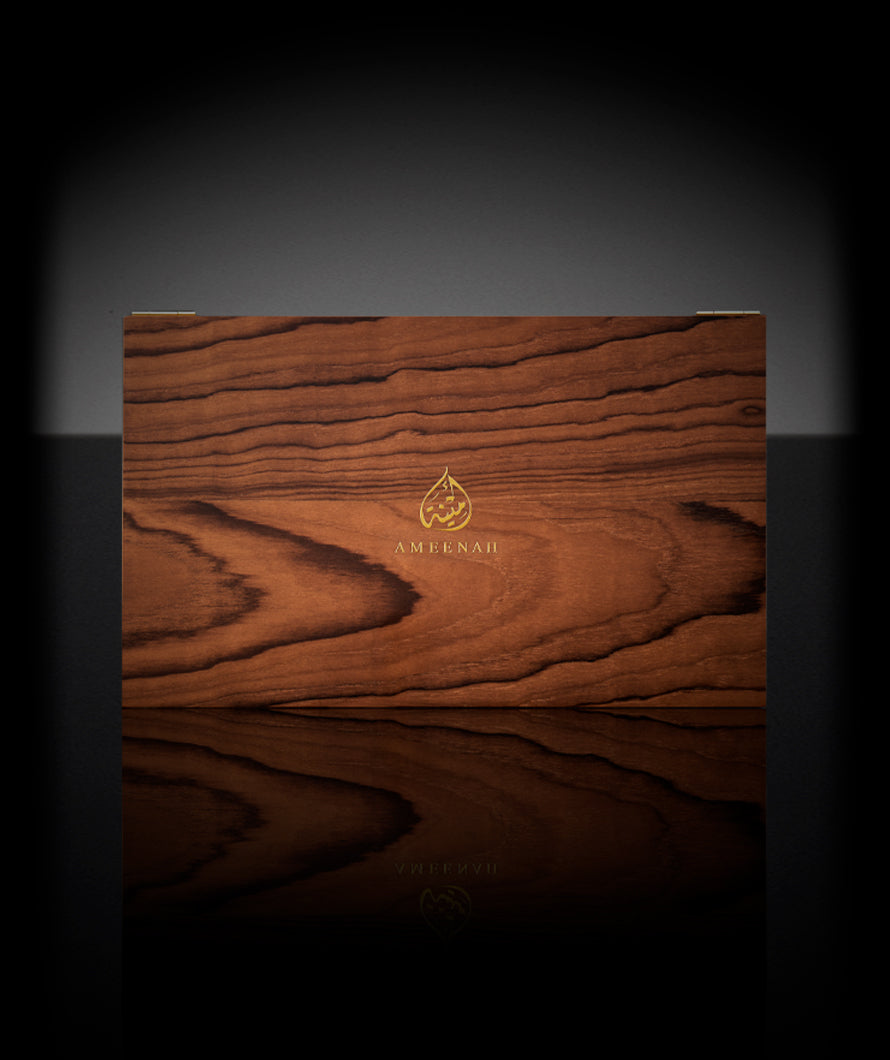 Natural brown wooden box containing Ameenah’s Oriental Collection perfumes , Musk, Amber, Oud, and Rose.