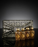 Natural brown wooden box  Wrapping with Luxury Fabric containing Ameenah’s Oriental Collection perfumes , Musk, Amber, Oud, and Rose.