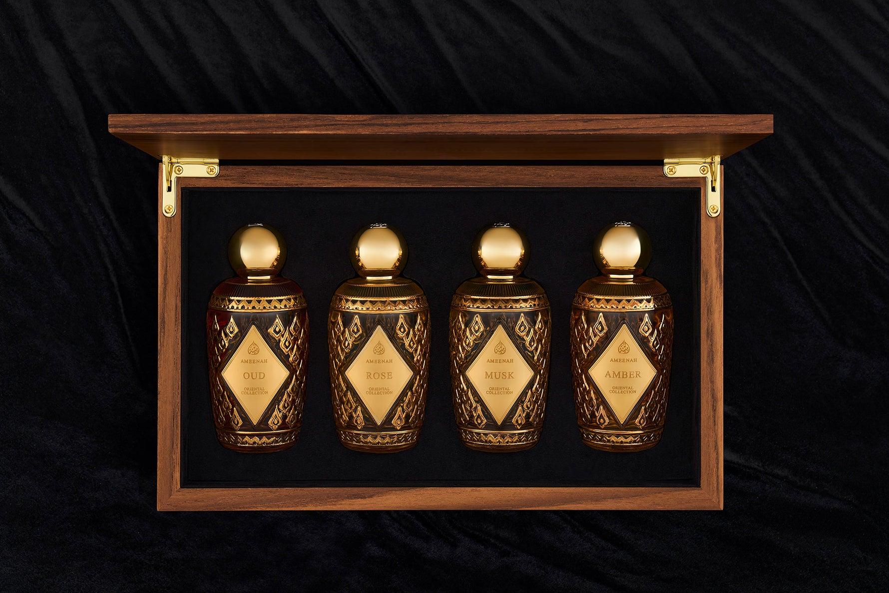 Natural brown wooden box containing Ameenah’s Oriental Collection perfumes , Musk, Amber, Oud, and Rose.