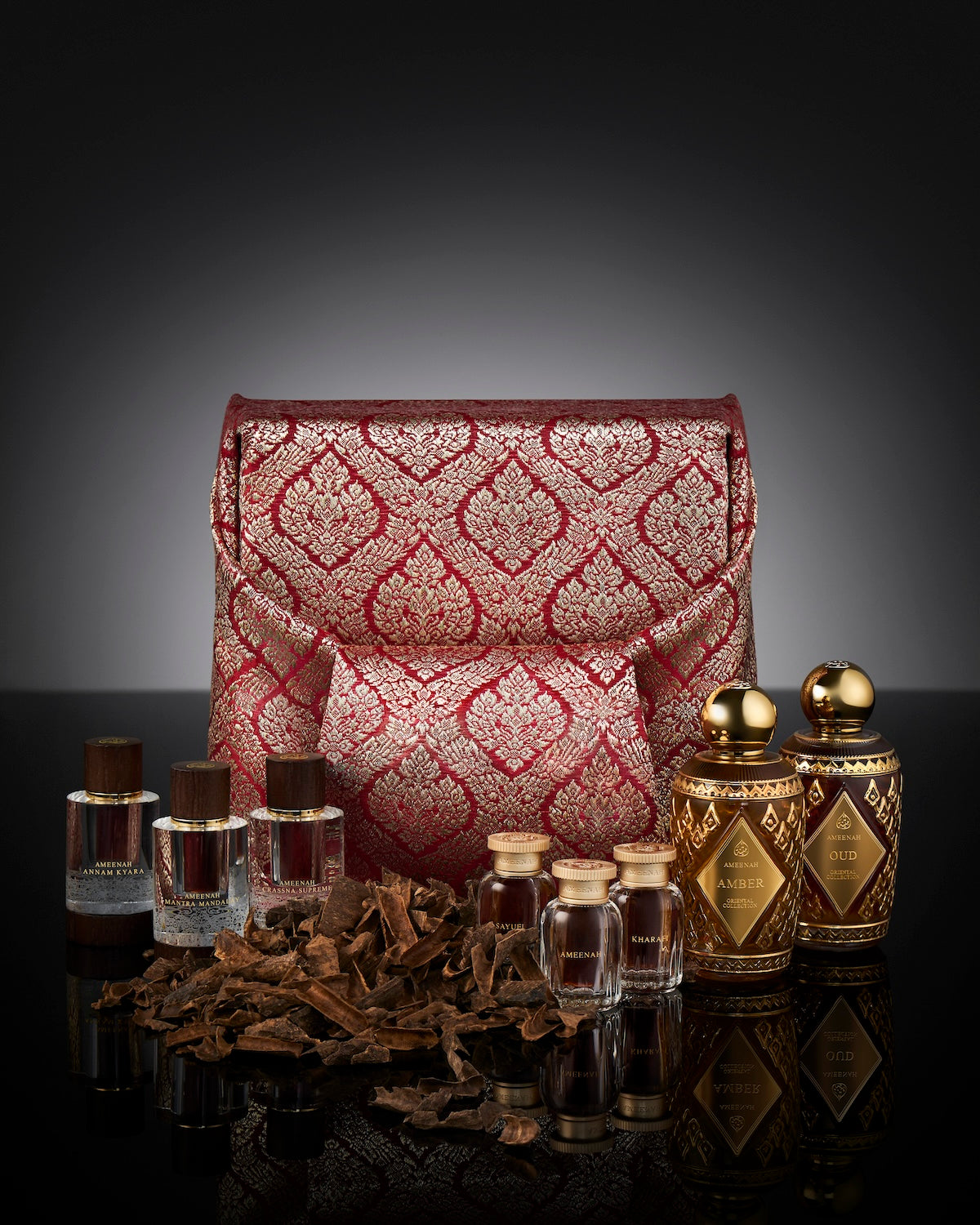 Close-up of the Prestige Gift Set wooden box Wrapped with Luxury Fabric with two Ameenah perfume bottles placed inside a black velvet interior.