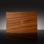 A three-slot Prestige Gift Set wooden box containing Ameenah perfumes and oud oils displayed on a dark velvet base.
